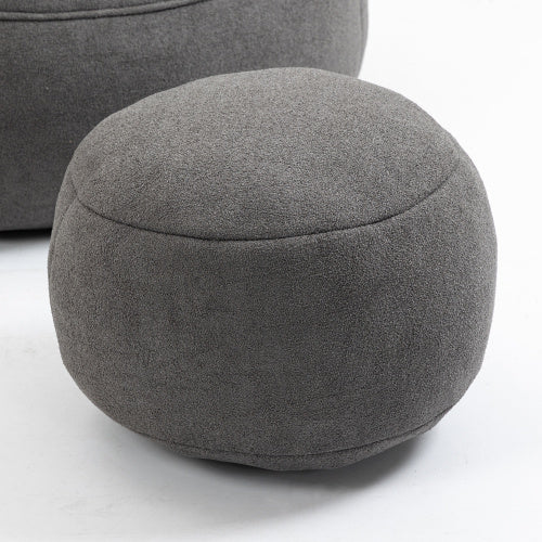 Close-up of dark grey bean bag sofa chair and footrest, showing soft material and footrest details