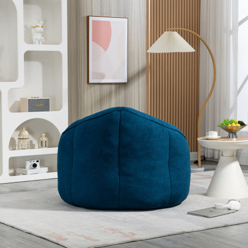 Back view of sapphire blue bean bag sofa chair with footrest, showing plush texture and design