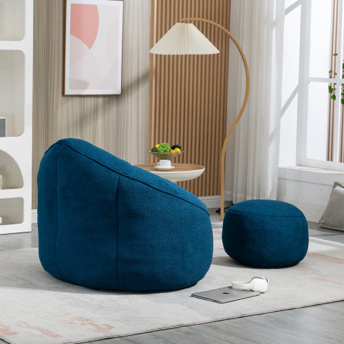 Side view of sapphire blue bean bag sofa chair with footrest, showing plush texture and design