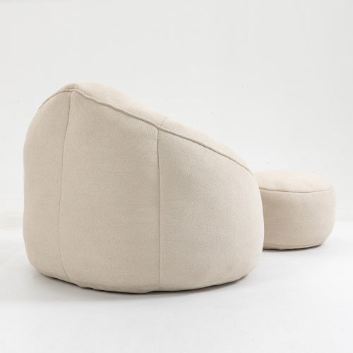 Back view of beige bean bag sofa chair with footrest, showing plush texture and design