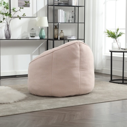 Back view of light pink bean bag sofa chair with footrest, showing plush texture and design