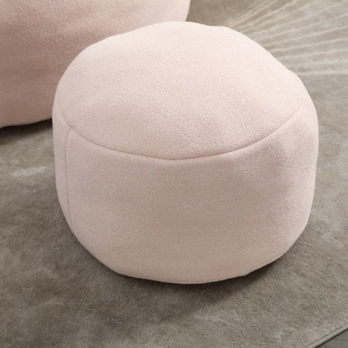 Close-up of light pink bean bag sofa chair and footrest, showing soft material and footrest details