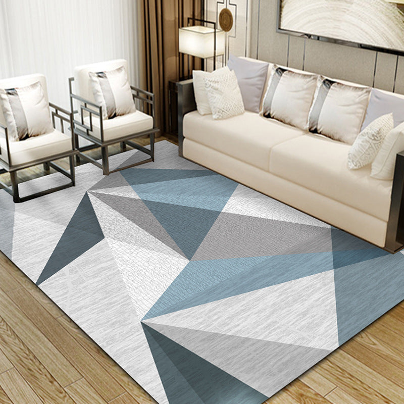 Dark blue, black, light brown, grey, and white irregular triangle pattern rug, modern and stylish