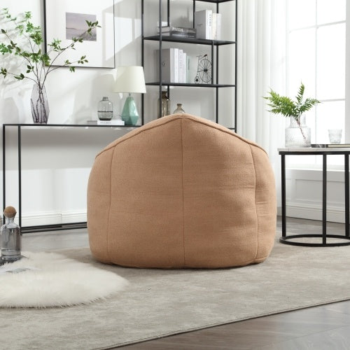 Back view of tan bean bag sofa chair with footrest, showing plush texture and design