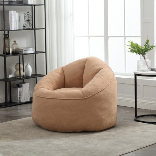 Angled view of tan bean bag sofa chair with footrest, cozy seating